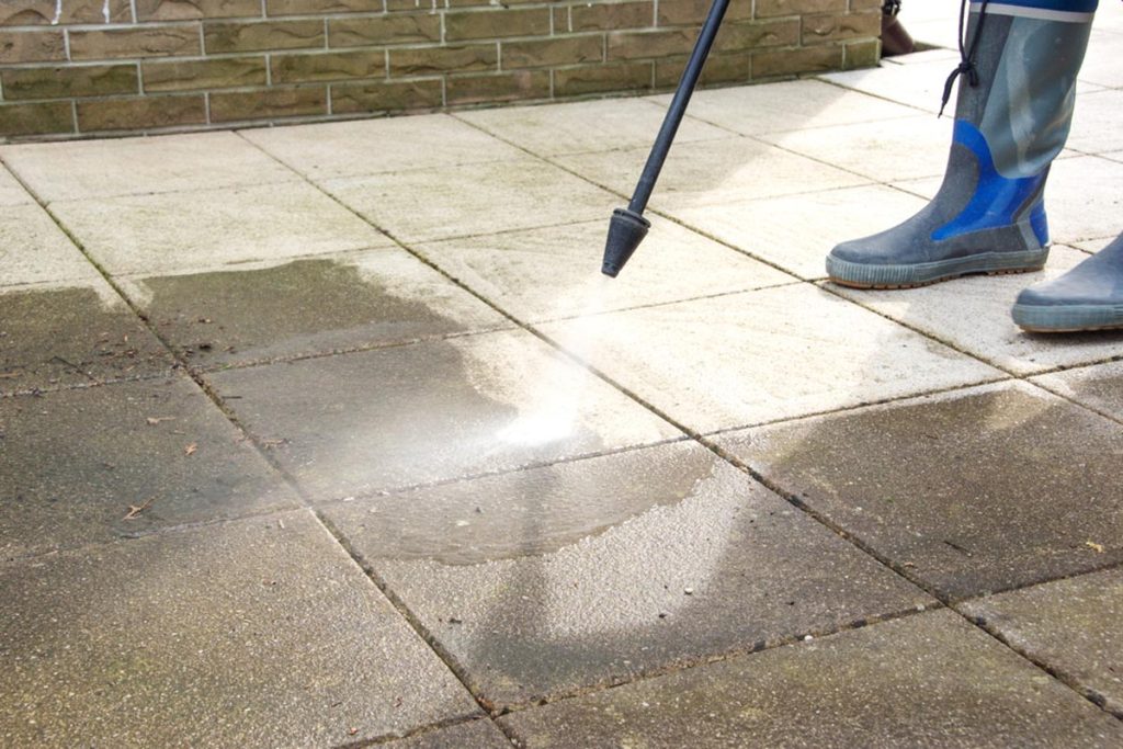 How can natural stone patio slabs be cleaned